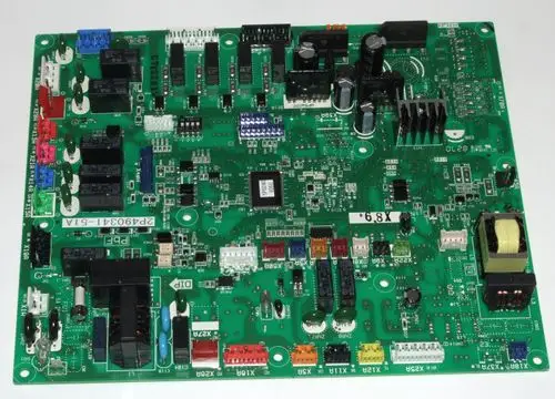 Grüne Hauptplatine mit verschiedenen elektrischen Komponenten und Anschlüssen, die für ein Daikin-System verwendet wird. Sichtbare Bauteile umfassen Relais, Steckverbindungen und Kühlkörper.